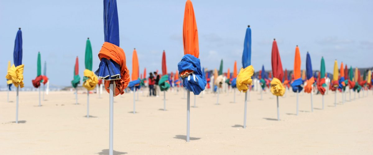 Parasols in front of the planches de Deauville, a famous wooden promenade on the beach in Deauville, France. This picture was taken two days before the 37th G8 summit, during which the whole area was under extremely high security measures ("sanctuarized zone"), and reserved to Heads of State, Heads of Government and members of their delegations.